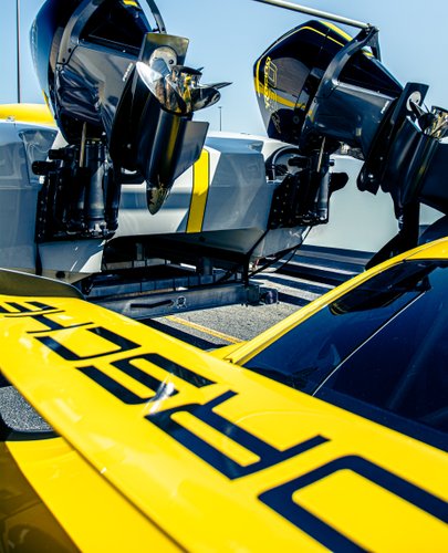 yellow porsche gt3 and yatch